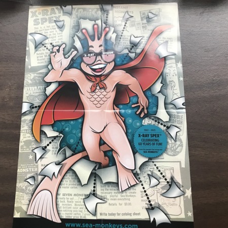 Poster Side: A Superhero Sea-Monkey wearing X-Ray Spex.